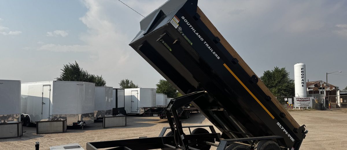 Dump trailer with the bed raised on its scissor hoist